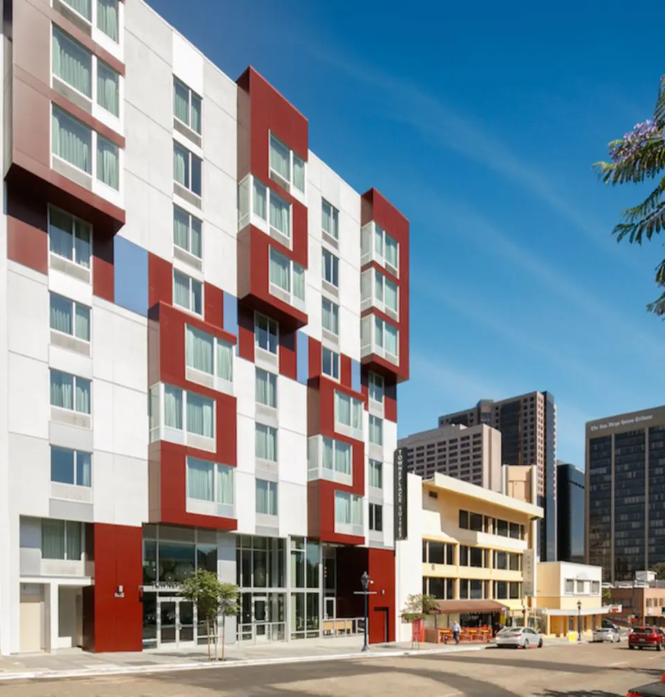 A building with many windows and red accents.