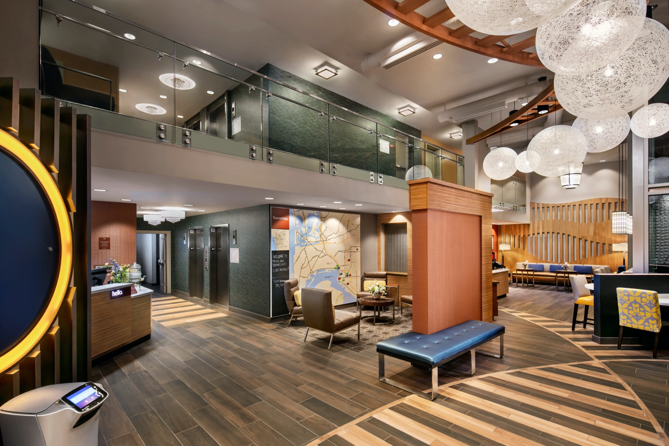 A lobby with chairs, tables and lights.